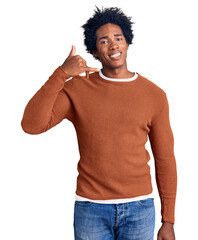 Poster - Handsome african american man with afro hair wearing casual clothes smiling doing phone gesture with hand and fingers like talking on the telephone. communicating concepts.