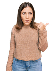 Poster - Young beautiful woman wearing casual clothes surprised pointing with hand finger to the side, open mouth amazed expression.