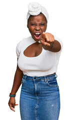 Sticker - Young african woman with turban wearing hair turban over isolated background pointing displeased and frustrated to the camera, angry and furious with you