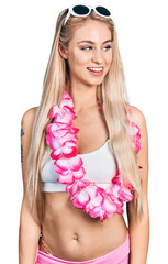 Sticker - Beautiful young blonde woman wearing bikini and hawaiian lei looking to side, relax profile pose with natural face and confident smile.