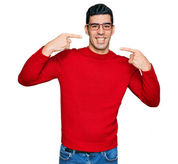 Wall Mural - Handsome hispanic man wearing casual clothes and glasses smiling cheerful showing and pointing with fingers teeth and mouth. dental health concept.