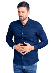 Poster - Young handsome man wearing casual shirt with hand on stomach because indigestion, painful illness feeling unwell. ache concept.