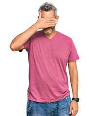 Poster - Middle age grey-haired man wearing casual clothes covering eyes with hand, looking serious and sad. sightless, hiding and rejection concept