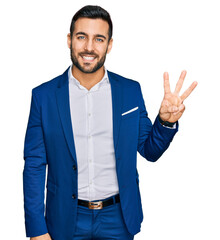 Wall Mural - Young hispanic man wearing business jacket showing and pointing up with fingers number three while smiling confident and happy.