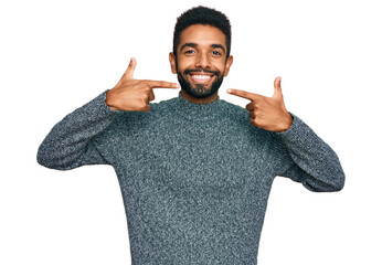 Sticker - Young african american man wearing casual clothes smiling cheerful showing and pointing with fingers teeth and mouth. dental health concept.