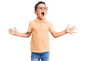 Wall Mural - Little cute boy kid wearing casual clothes and glasses crazy and mad shouting and yelling with aggressive expression and arms raised. frustration concept.