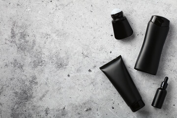 Wall Mural - premium men's cosmetics top view. flat lay black shower gel tube, shampoo bottle, deodorant, serum o