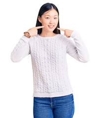 Poster - Young beautiful chinese woman wearing casual sweater smiling cheerful showing and pointing with fingers teeth and mouth. dental health concept.