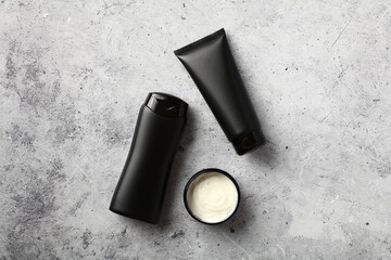 Wall Mural - jar of hair balm, shampoo bottle and tube with hair gel on stone desk table. men's hair care concept