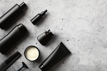 Wall Mural - black cosmetic bottles set on stone table. men's beauty products concept.