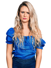 Poster - Young blonde woman wearing casual clothes skeptic and nervous, frowning upset because of problem. negative person.