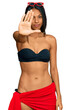 Young african american woman wearing bikini doing stop sing with palm of the hand. warning expression with negative and serious gesture on the face.