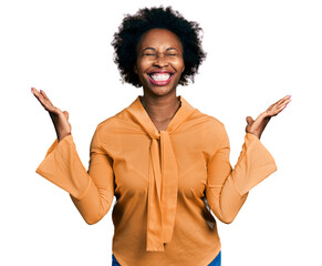 Sticker - African american woman with afro hair wearing elegant shirt celebrating mad and crazy for success with arms raised and closed eyes screaming excited. winner concept