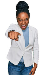 Wall Mural - Young african american woman wearing business clothes pointing displeased and frustrated to the camera, angry and furious with you