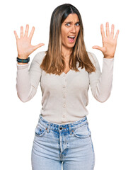 Wall Mural - Young woman wearing casual clothes afraid and terrified with fear expression stop gesture with hands, shouting in shock. panic concept.