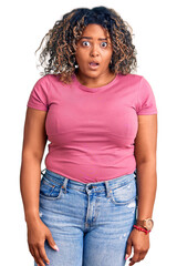 Wall Mural - Young african american plus size woman wearing casual clothes in shock face, looking skeptical and sarcastic, surprised with open mouth