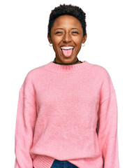 Wall Mural - Young african american woman wearing casual clothes sticking tongue out happy with funny expression. emotion concept.