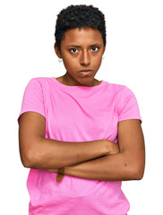 Wall Mural - Young african american woman wearing casual clothes skeptic and nervous, disapproving expression on face with crossed arms. negative person.