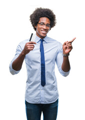 Poster - Afro american man holding credit card over isolated background very happy pointing with hand and finger to the side