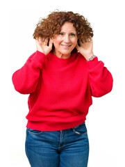 Sticker - Beautiful middle ager senior woman red winter sweater over isolated background Trying to hear both hands on ear gesture, curious for gossip. Hearing problem, deaf