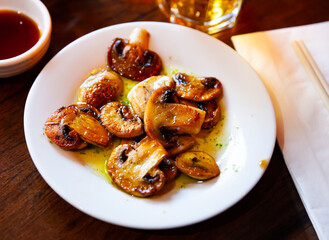 Wall Mural - Popular Japanese style grilled sliced mushrooms topped with spicy green sauce