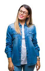 Poster - Young beautiful woman over wearing glasses over isolated background winking looking at the camera with sexy expression, cheerful and happy face.