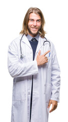 Poster - young handsome doctor man with long hair over isolated background cheerful with a smile of face poin