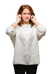 Poster - Young beautiful woman over isolated background wearing winter sweater covering ears with fingers with annoyed expression for the noise of loud music. Deaf concept.