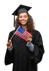 Sticker - Young hispanic woman wearing graduation uniform holding flag of United States with a happy face standing and smiling with a confident smile showing teeth