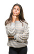 © Krakenimages.com - Young beautiful arab woman wearing winter sweater over isolated background with hand on chin thinking about question, pensive expression. Smiling with thoughtful face. Doubt concept.