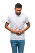© Krakenimages.com - Adult hispanic man over isolated background with hand on stomach because indigestion, painful illness feeling unwell. Ache concept.