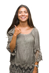 Canvas Print - Young beautiful arab woman over isolated background doing happy thumbs up gesture with hand. Approving expression looking at the camera with showing success.