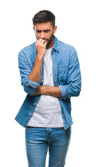 Canvas Print - Adult hispanic man over isolated background looking stressed and nervous with hands on mouth biting nails. Anxiety problem.