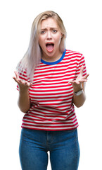 Poster - Young blonde woman over isolated background crazy and mad shouting and yelling with aggressive expression and arms raised. Frustration concept.