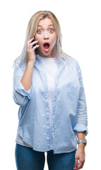 Poster - Young blonde woman talking using smarpthone over isolated background scared in shock with a surprise face, afraid and excited with fear expression