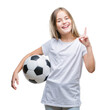 © Krakenimages.com - Young beautiful girl holding soccer football ball over isolated background surprised with an idea or question pointing finger with happy face, number one