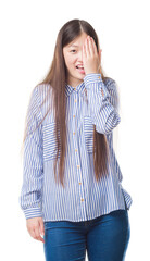 Sticker - Young Chinese woman over isolated background covering one eye with hand with confident smile on face and surprise emotion.