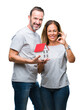 © Krakenimages.com - Middle age hispanic casual couple buying new house over isolated background doing ok sign with fingers, excellent symbol