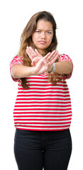 Canvas Print - Young beautiful brunette woman wearing stripes t-shirt over isolated background Rejection expression crossing arms and palms doing negative sign, angry face