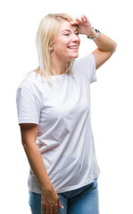 Poster - Young beautiful blonde woman wearing white t-shirt over isolated background very happy and smiling looking far away with hand over head. Searching concept.