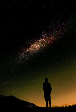 Silhouette Of Man Standing Under Starry Night