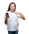 © Krakenimages.com - Young braided hair african american girl showing using smartphone over isolated background with surprise face pointing finger to himself