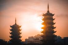 Silhouette Of Sun And Moon Pagodas In Guilin, Guangxi, China At Sunset