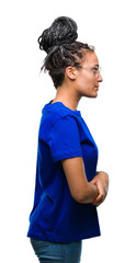 Canvas Print - Young braided hair african american girl wearing glasses over isolated background looking to side, relax profile pose with natural face with confident smile.