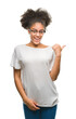 © Krakenimages.com - Young afro american woman wearing glasses over isolated background smiling with happy face looking and pointing to the side with thumb up.