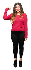 Poster - Young beautiful woman wearing red sweater Smiling pointing to head with one finger, great idea or thought, good memory