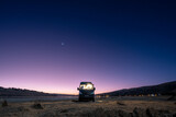 Campervan facing the blue hour with the last gleams of sunshine