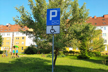 Road Sign Parking Only For Disabled Drivers On Modern Residential Neighborhood Background. Concept Of Accessible Parking And Locations. Adapted Spaces For People With Disabilities. Inclusion.