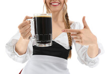 Beautiful Octoberfest Waitress Pointing At Beer On White Background, Closeup