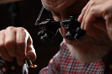 Wall Mural - Professional jeweler working with gemstone, closeup view